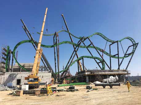 Cranes installing an amusement ride structure